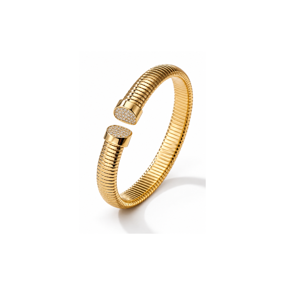 Lyora gold-tone ribbed open cuff with pavé-style tips, isolated on white