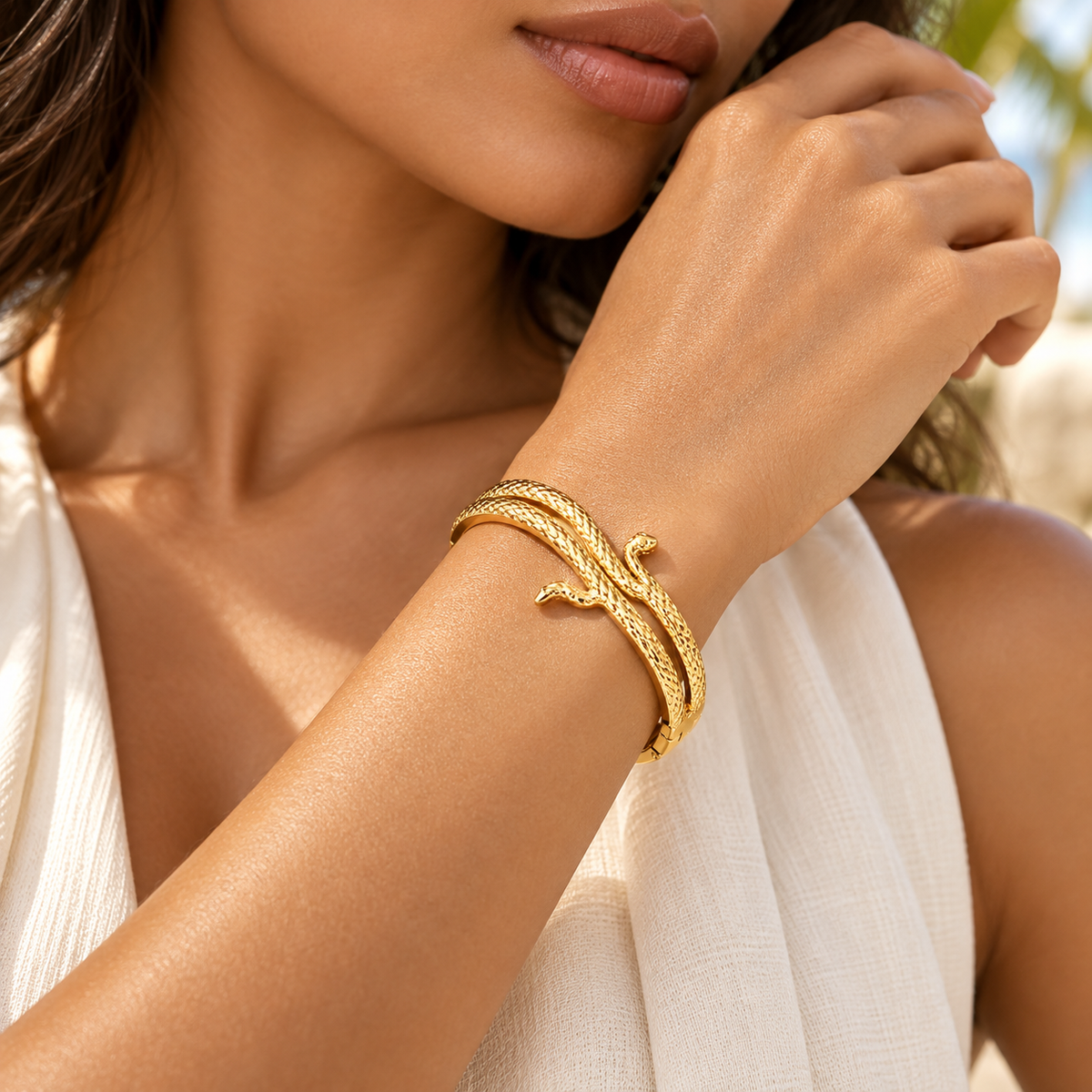 Model wearing Lyora gold-tone serpent wrap bangle on the wrist