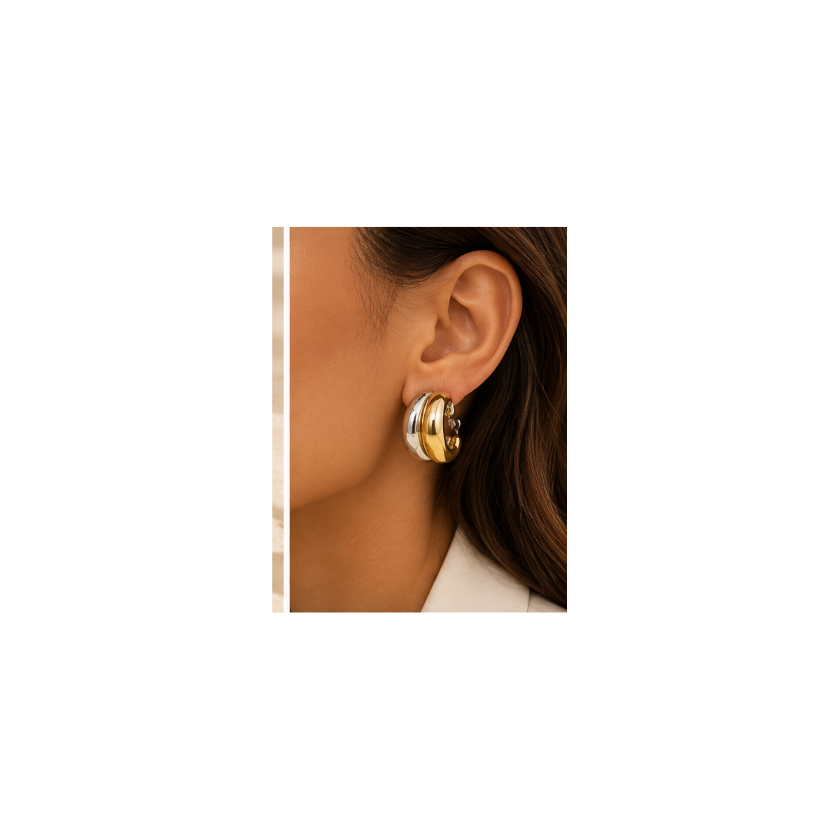 Model wearing Lyora gold and silver sculptural half-hoop earrings