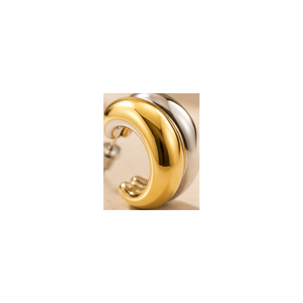 Macro details on Lyora gold and silver two-tone hoop earrings