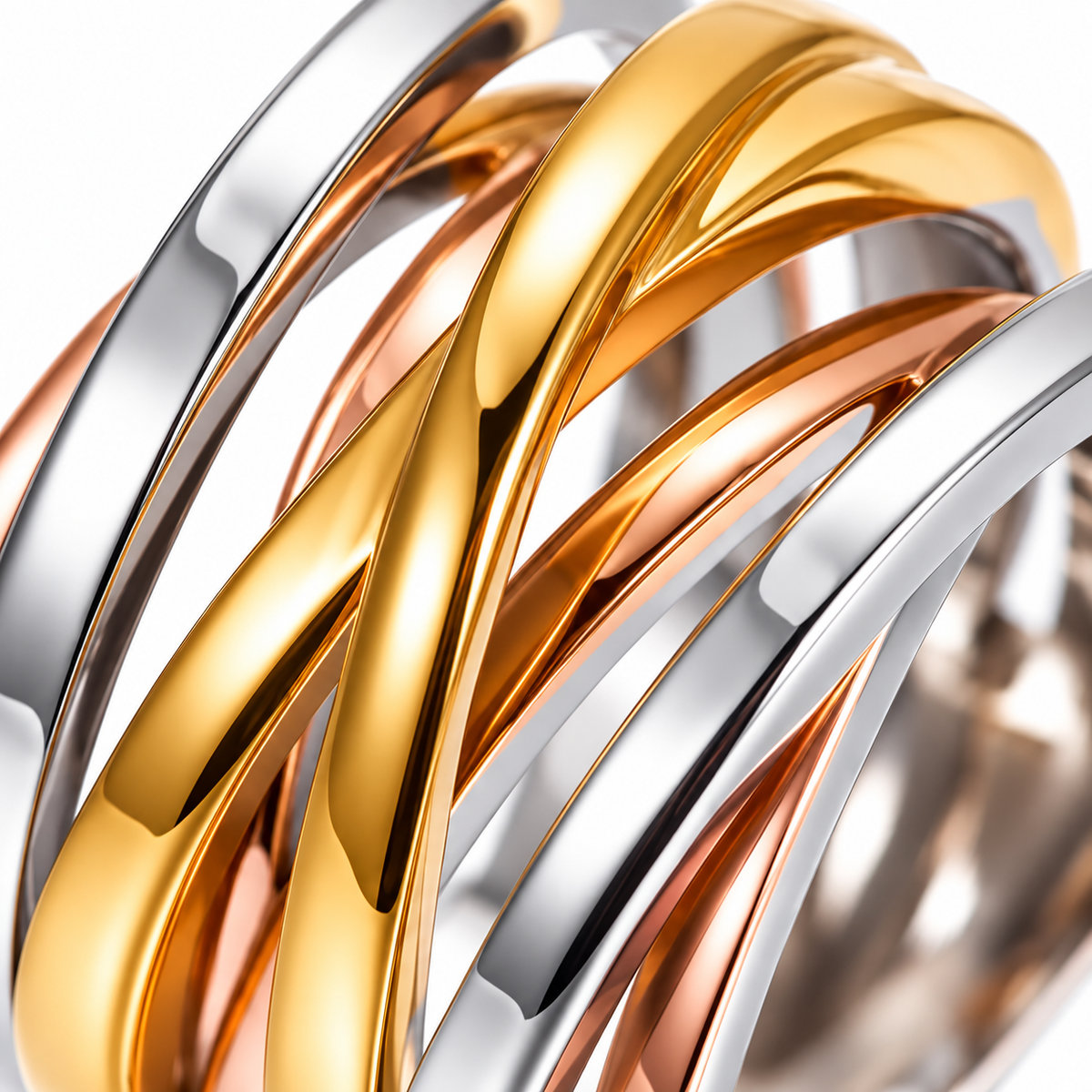 Macro of the sculptural gold silver and rose-gold-tone bands